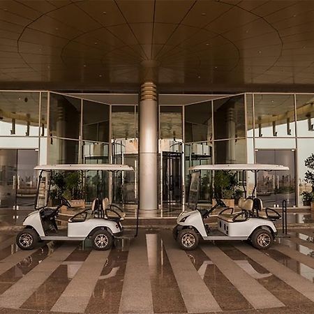 Millennium Hail Hotel Exterior photo Golf carts at the entrance of the hotel