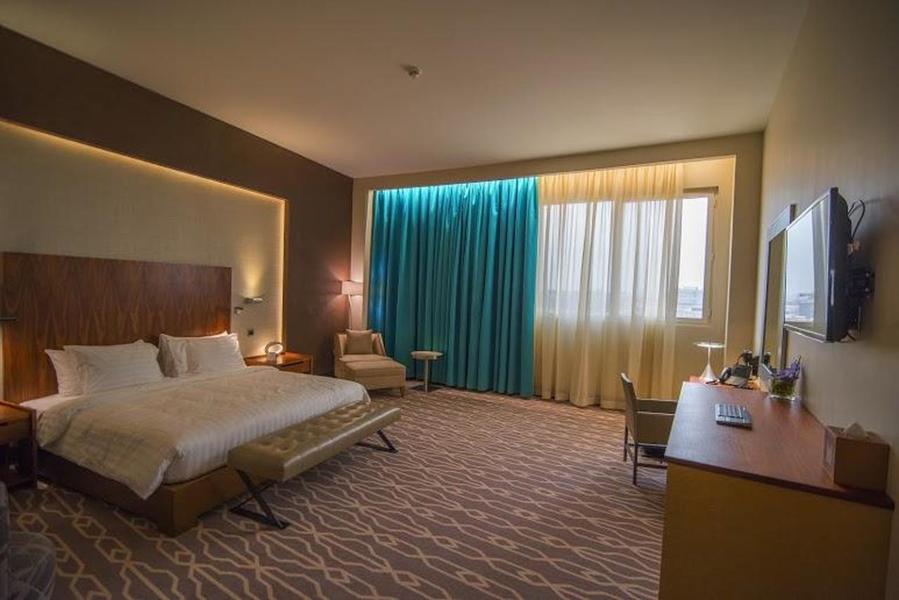 Millennium Hail Hotel Exterior photo A room at the hotel