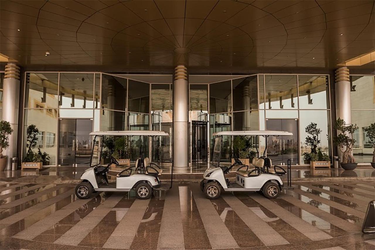 Millennium Hail Hotel Exterior photo Golf carts at the entrance of the hotel